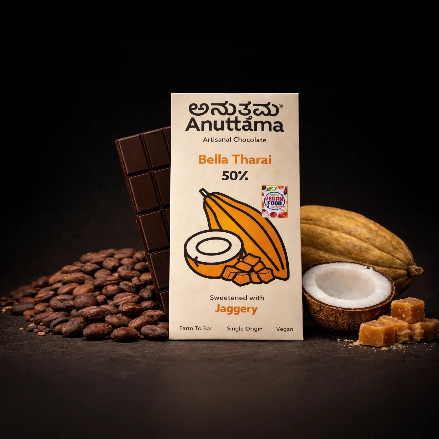 Anuttama Bella Tharai 50% artisanal chocolate bar, sweetened with jaggery, surrounded by cocoa beans, coconut, and jaggery cubes