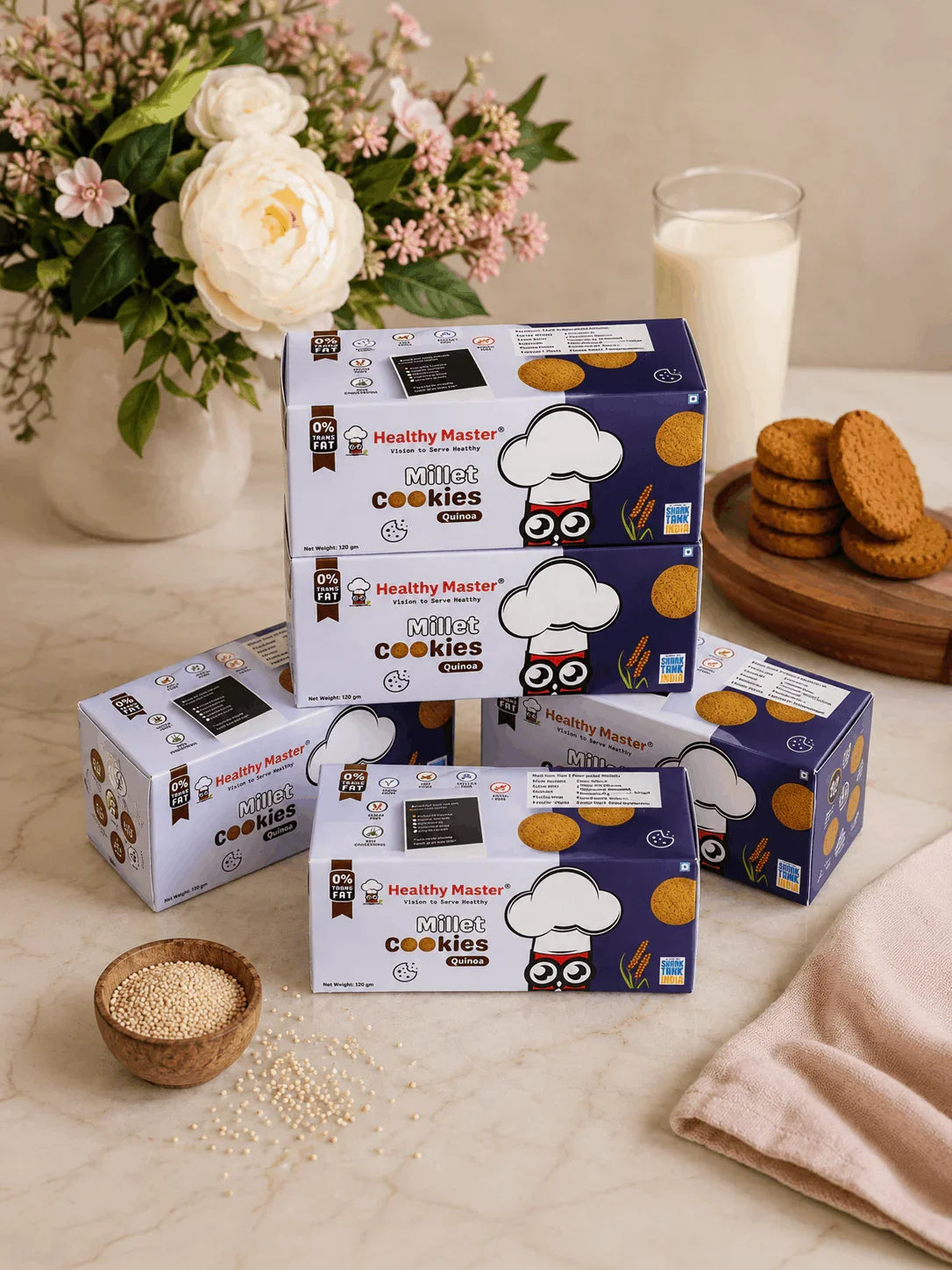 Healthy Master Millet Cookies with quinoa, 0% trans fat, displayed with milk, flowers, and raw grains